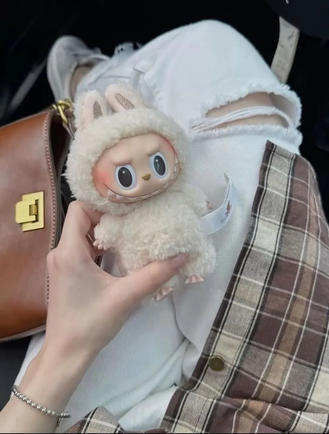 Beige Labubu figure with a streetwear outfit