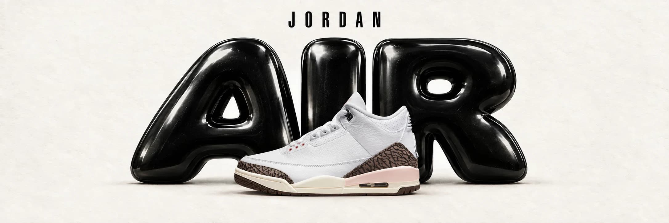 White Air Jordan 3 with elephant print in front of black AIR lettering