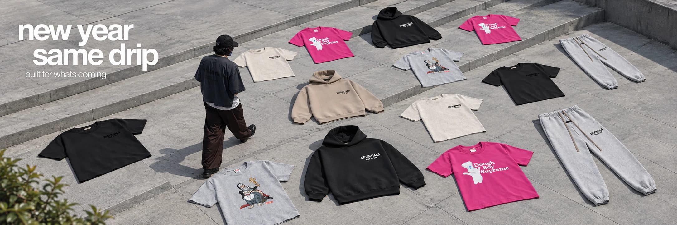 Fear of God Essentials and Supreme clothing laid across a concrete plaza